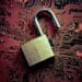 open padlock on red circuit board background