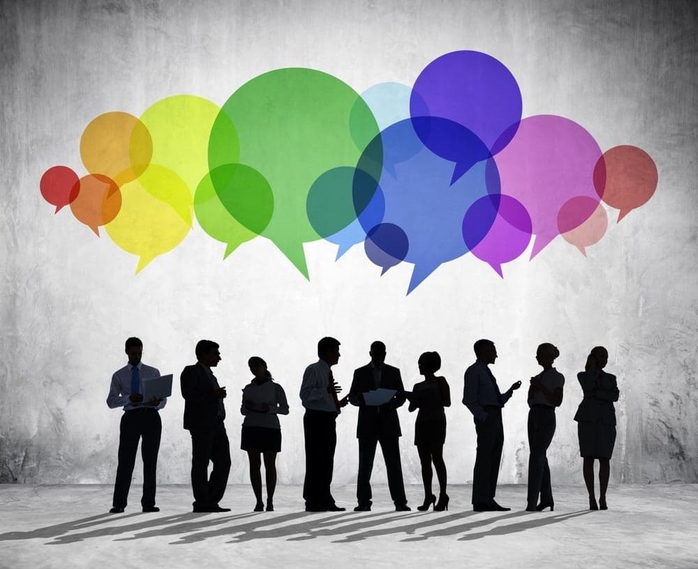 multicolored speech bubbles over businesspeople in silhouette