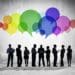 multicolored speech bubbles over businesspeople in silhouette