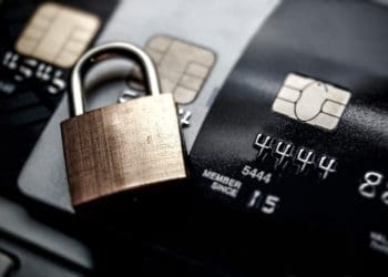 gold padlock on black and silver credit cards