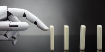 robot hand pushing dominoes in a line