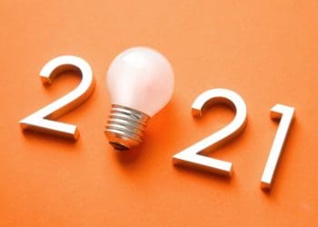2021 with light bulb in place of zero on orange background