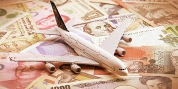 miniature airplane on global currency