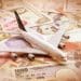 miniature airplane on global currency