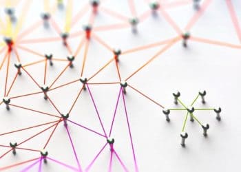 groups of straight pins connected by colorful thread
