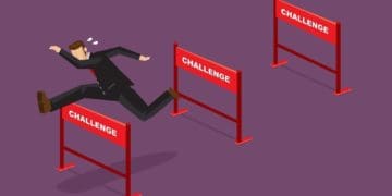 businessman jumping over hurdles with text challenge on them