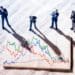 businessmen in miniature studying volatile stock market