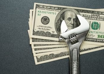 wrench with 100 dollar bills