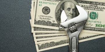 wrench with 100 dollar bills