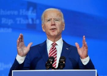 President Biden at podium on blue background