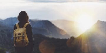 woman looking at horizon from mountain top
