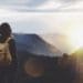 woman looking at horizon from mountain top