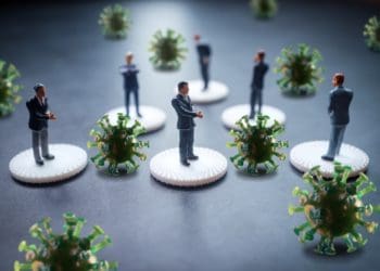 mini businessmen separated by COVID particles