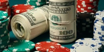 rolls of cash amid stacks of poker chips