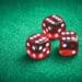 three red dice on green felt tabletop