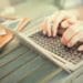 hands typing on laptop, smartphones on the table, work anywhere concept