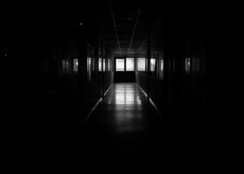 A dark hallway in an institution of higher education.