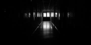 A dark hallway in an institution of higher education.