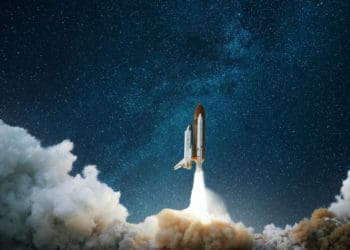 space shuttle launching into space amid clouds of smoke