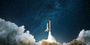 space shuttle launching into space amid clouds of smoke