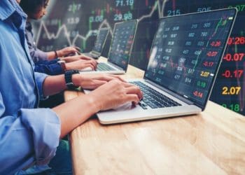 traders working on laptops