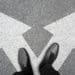 businessman in black shoes standing at the crossroad making decision which way to go