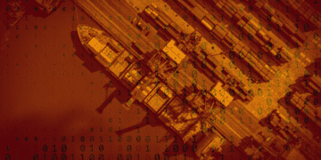 Overhead view of a shipping port is overlain with binary code, representing data supply chain.