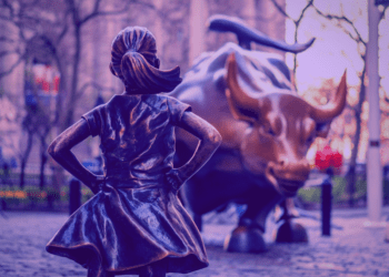 The bronze statues fearless girl and charging bull face each other down on Wall Street in New York.