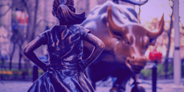 The bronze statues fearless girl and charging bull face each other down on Wall Street in New York.