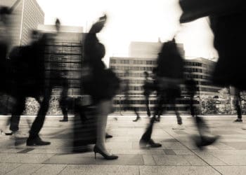 Blurred shot of business people walking outside.