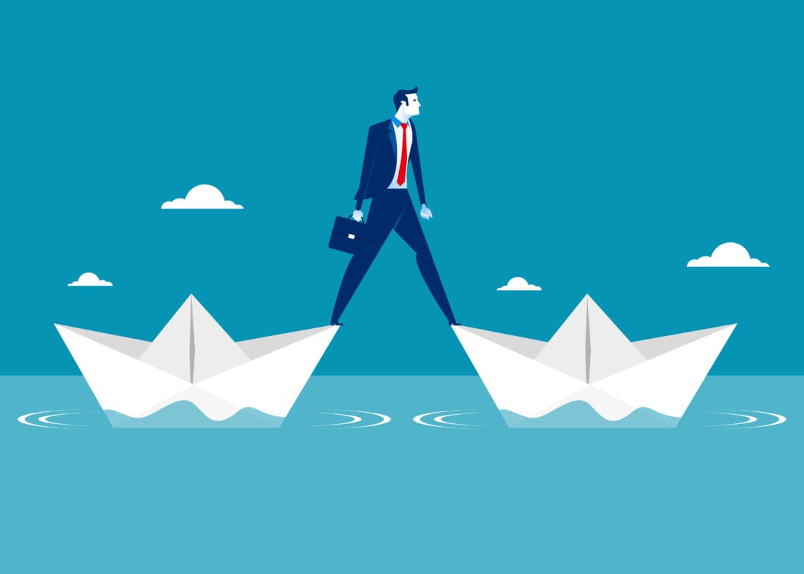 Illustration of a man standing on two paper boats in the ocean.