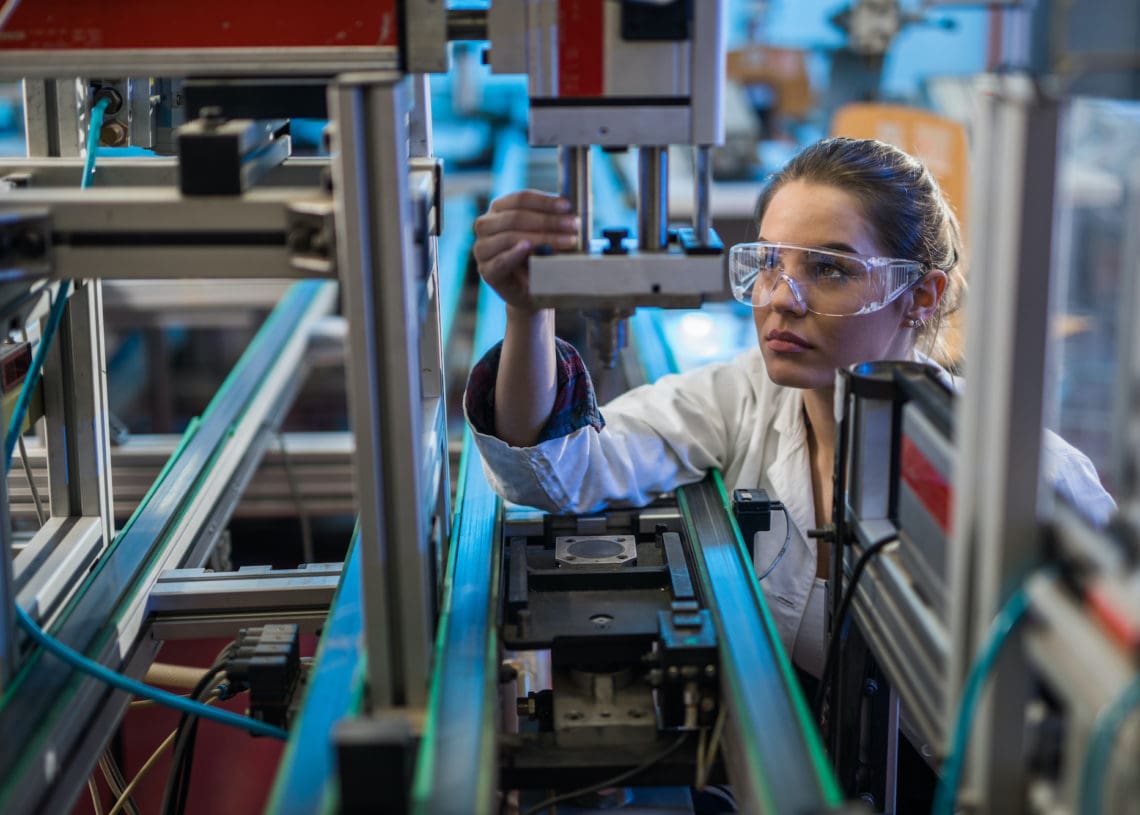 A quality control worker at a Flex manufacturing site inspects a product.