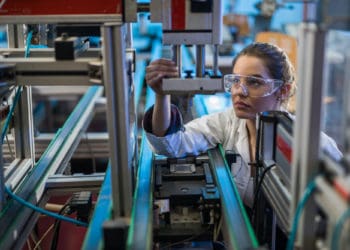 A quality control worker at a Flex manufacturing site inspects a product.