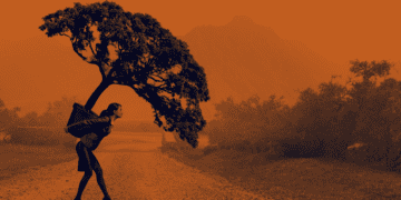 A chief compliance officer carries a large potted tree on her back.