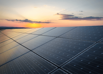 Solar panels sit before a setting sun, representing a potential avenue of ESG strategy.