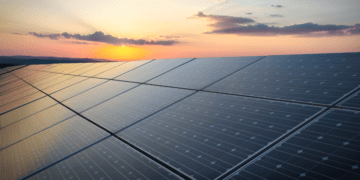 Solar panels sit before a setting sun, representing a potential avenue of ESG strategy.