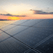 Solar panels sit before a setting sun, representing a potential avenue of ESG strategy.