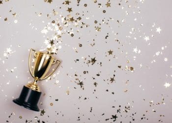 sparkles grey background with a winners cup