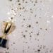 sparkles grey background with a winners cup
