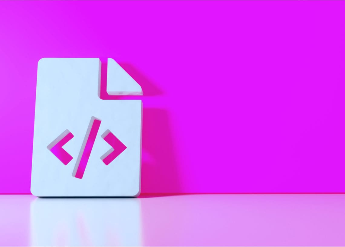 A white paper sign bearing code brackets, a stand in for digital savvy, leans against a pink wall