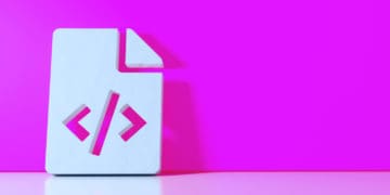 A white paper sign bearing code brackets, a stand in for digital savvy, leans against a pink wall