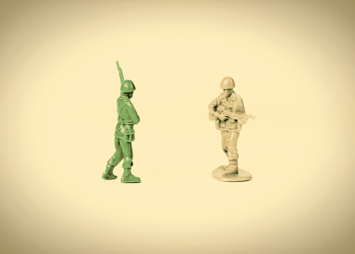 two toy soldiers face off.