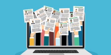Illustration of a laptop showing a dozen hands holding up their resumes.
