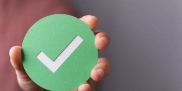 hand holding green checkmark symbol