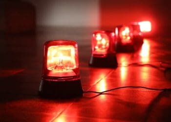 large red, flashing alarm lights on dark background