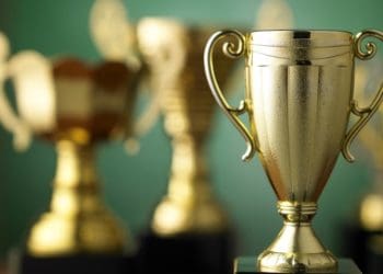 gold trophy in foreground with out of focus trophies in background