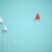 red paper plane out of line with white paper planes, concept of disruption