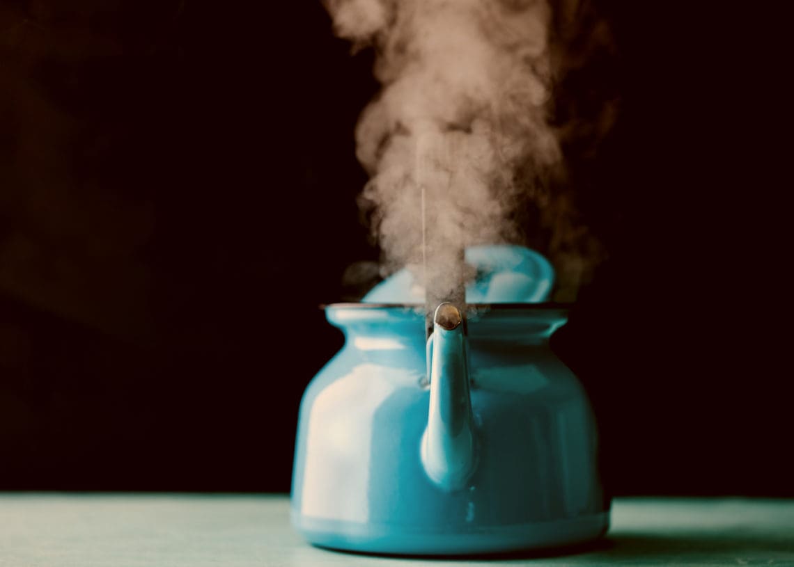 A boiling kettle is viewed head on.