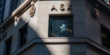 A man is seen talking in the window of the Australia Securities Exchange in Sydney.