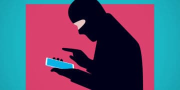 Illustration of a masked fraud actor using his smartphone.